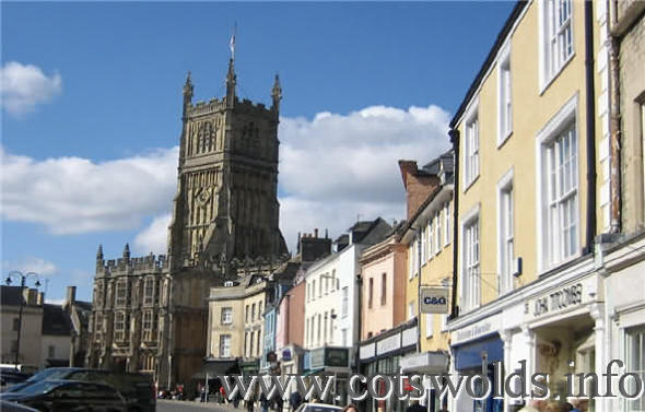 Cirencester main shopping street with Church of St. John in background