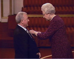 Mike being awarded his MBE by the Queen