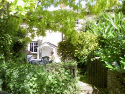 Outside there is a pretty garden with table and chairs, which has views over the green and ford.